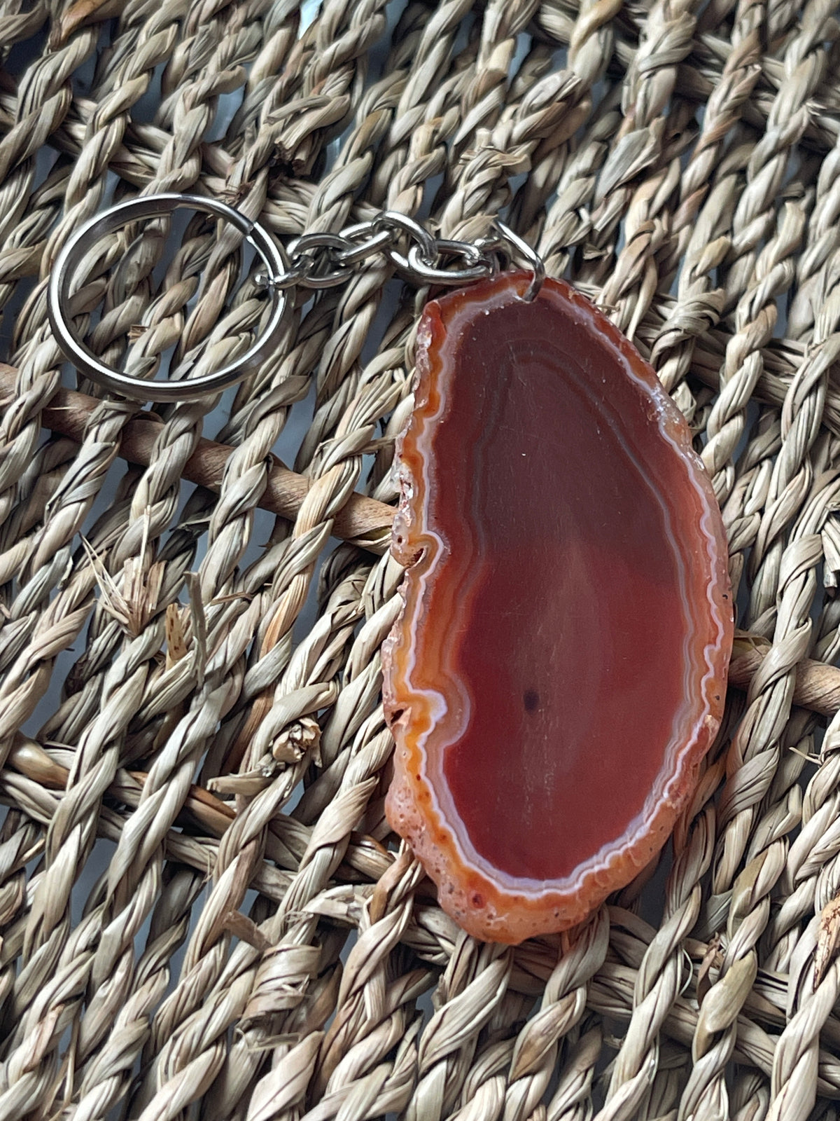 Agate slice keychain on a woven surface
