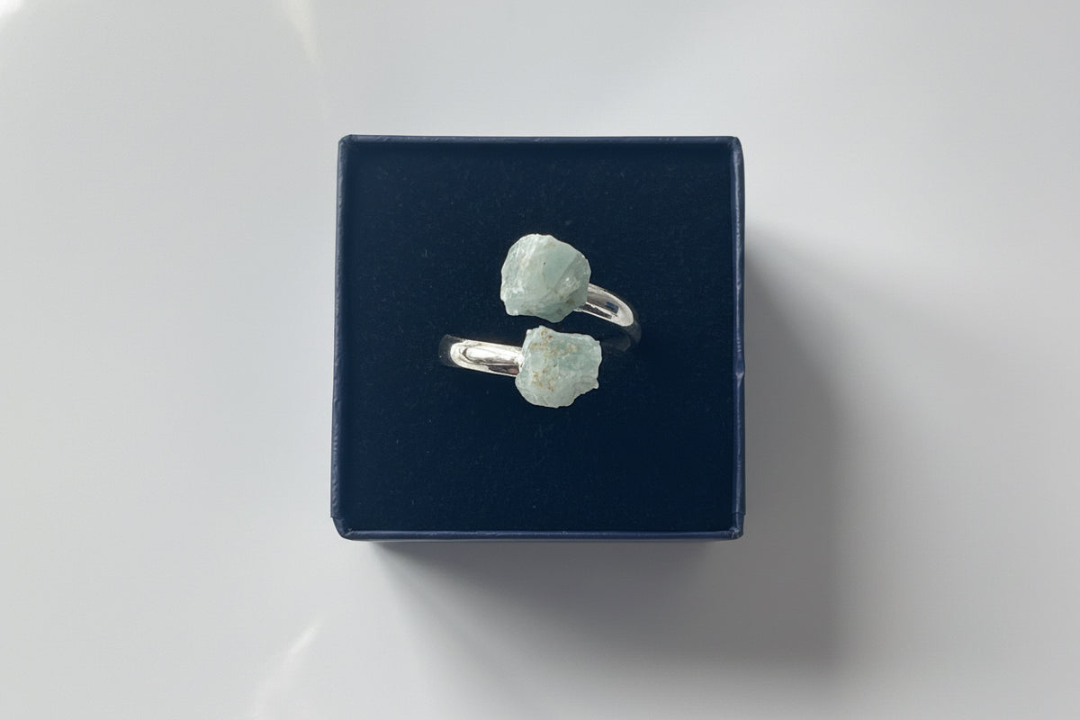 Aquamarine Adjustable Natural Ring Sliver siting inside a small white jewelry box