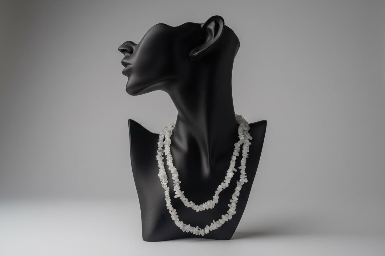 Black necklace display with decorative Rainbow_Moonstone_Necklace_30-32_Inches white stones with a gray backdrop in a studio