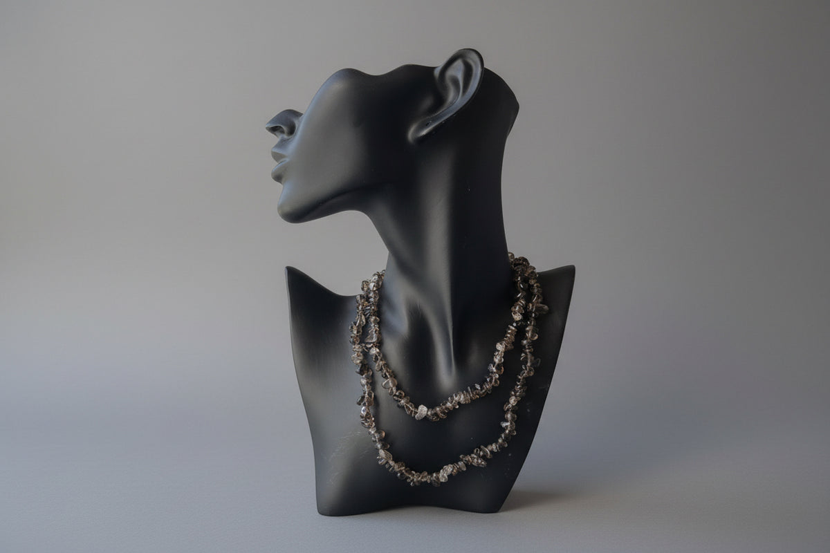 Black jewelry display item with a smoky-quartz-necklaces-30-32-inches on a reflective gray studio backdrop