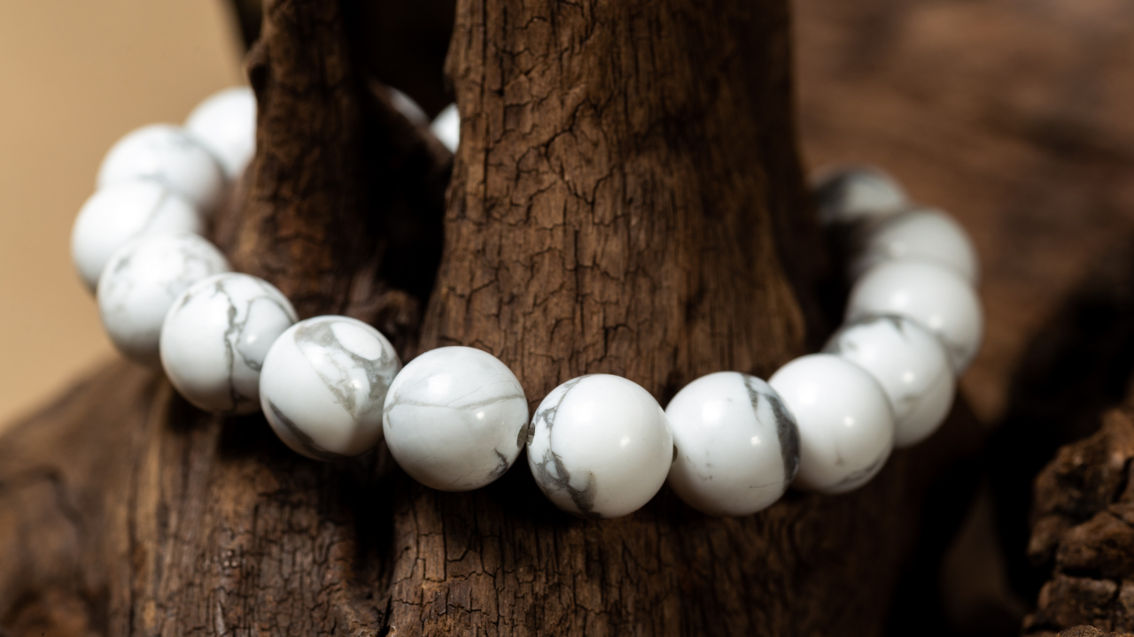 Polished Howlite crystal stone on a wooden surface