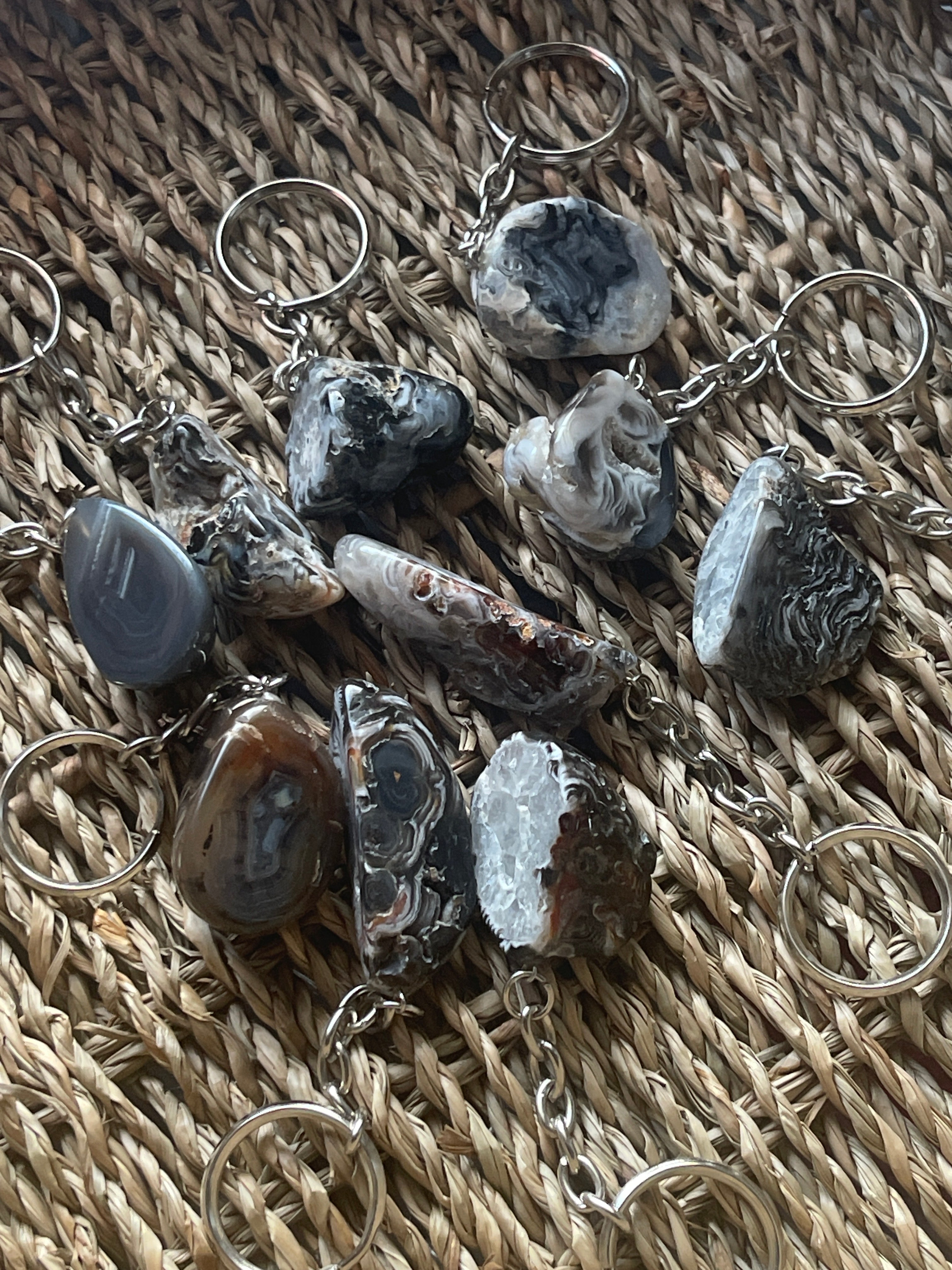 Keychains with natural stone pendants on a woven surface