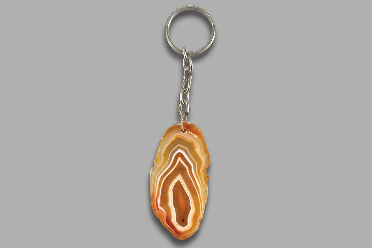 An agate slice keychain with a polished stone surface, attached to a metal keyring.