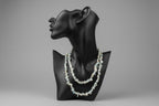 Amazonite_Chip_Necklace on a black neck shaped stand with a gray background