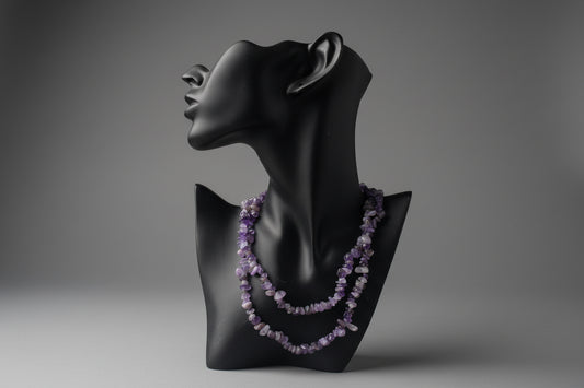Black mannequin with a purple beaded Amethyst Chip Necklace on a textured surface.