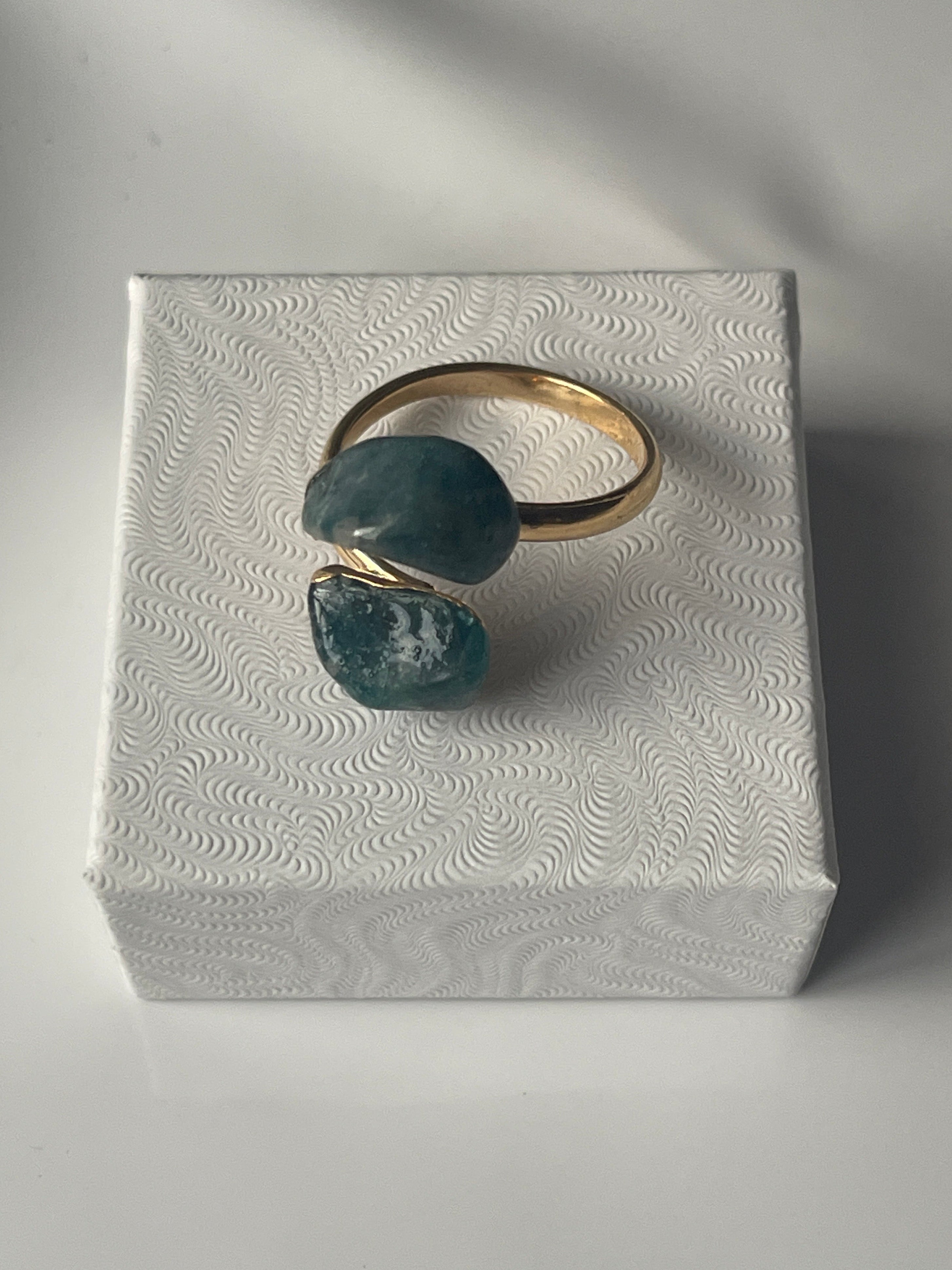 Apatite gold plated Ring on top of a small white jewelry box in Florida 