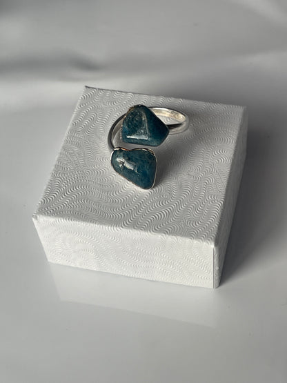 Apatite adjustable silver plated ring sitting on a white luxury jewelry box in Florida 