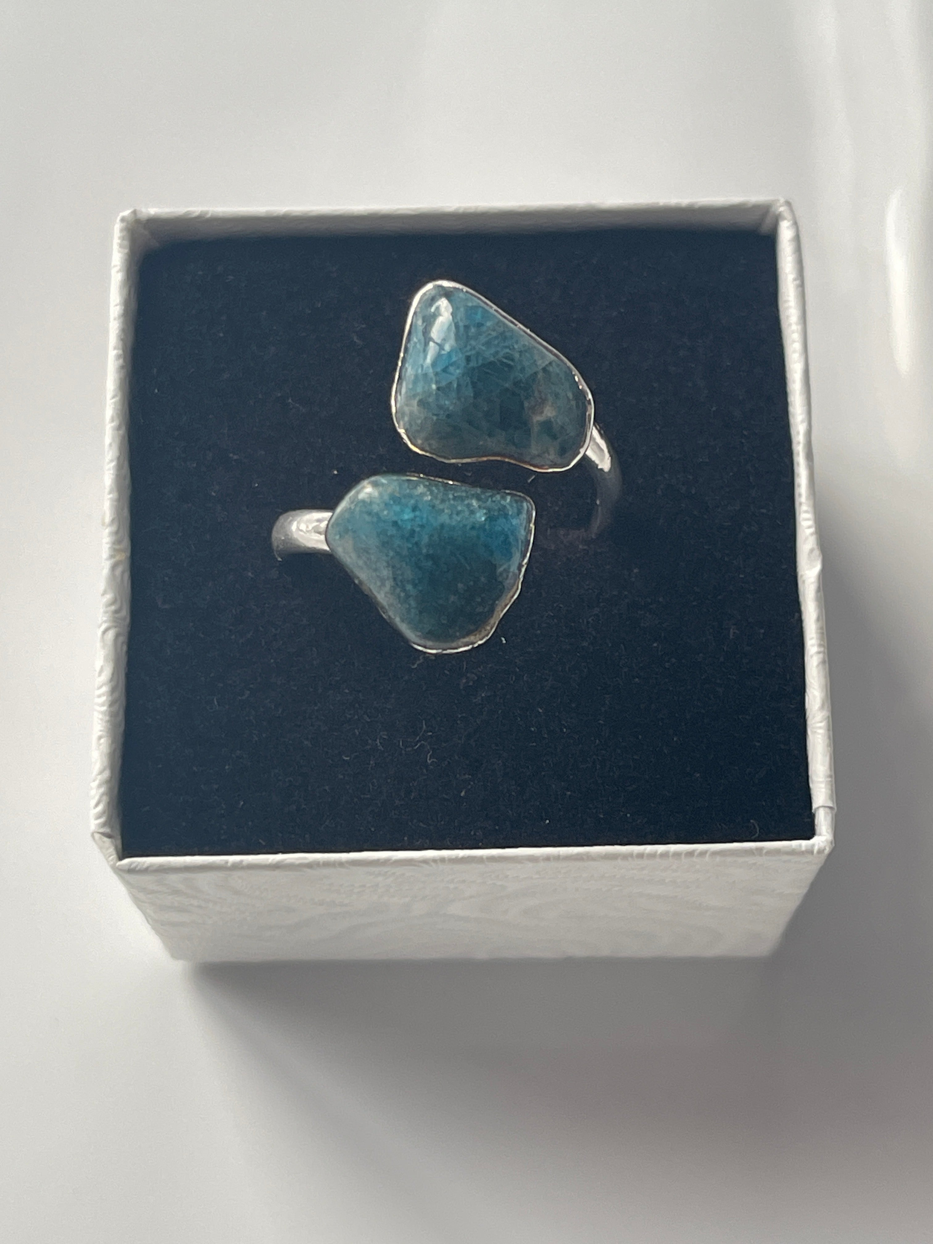 Apatite adjustable silver plated Ring inside a white and black jewelry box 