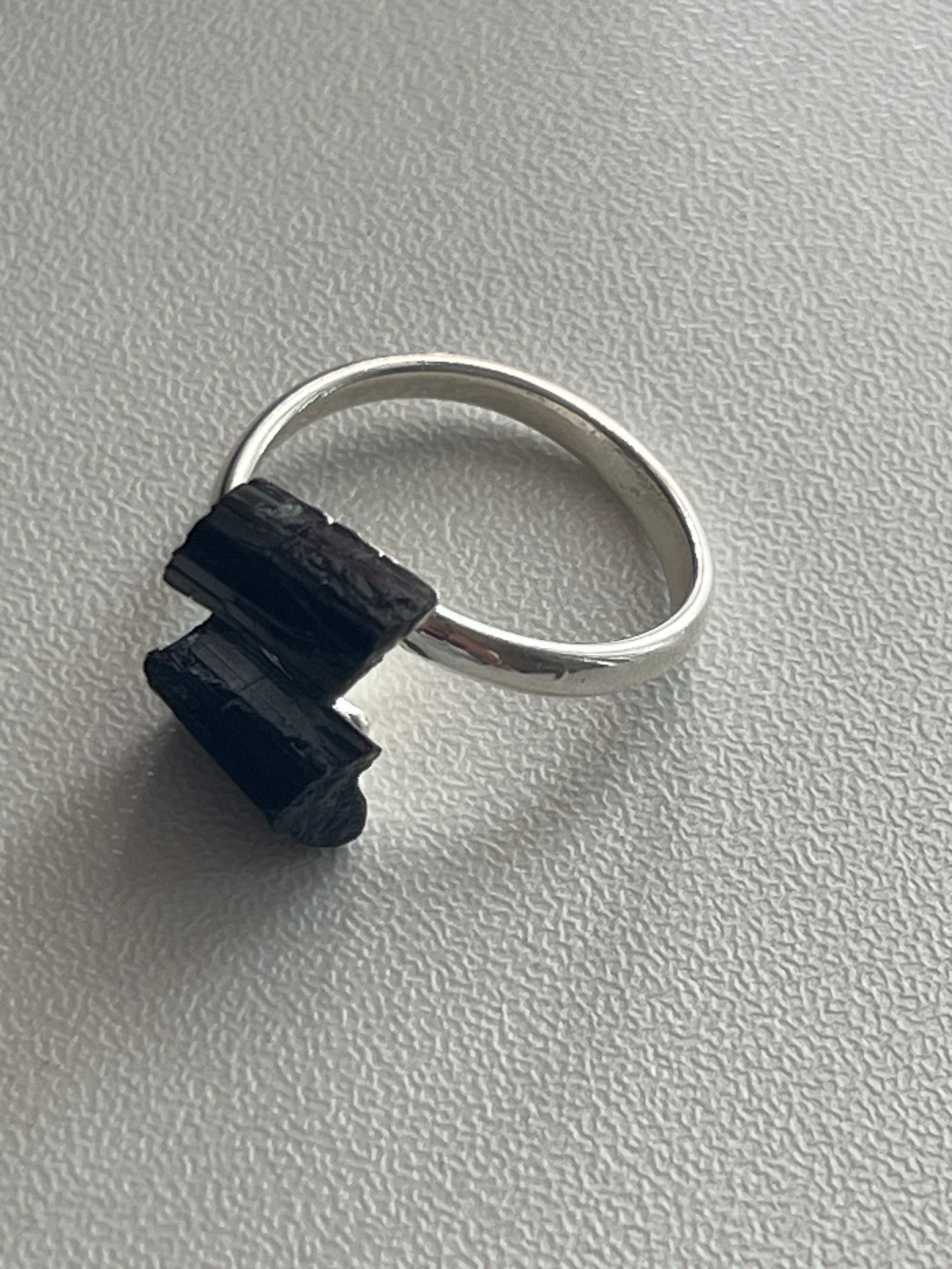 Black Adjustable Silver plated Tourmaline Ring at Pure Energy Crystals In Florida  Silver ring with a black stone on a gray background