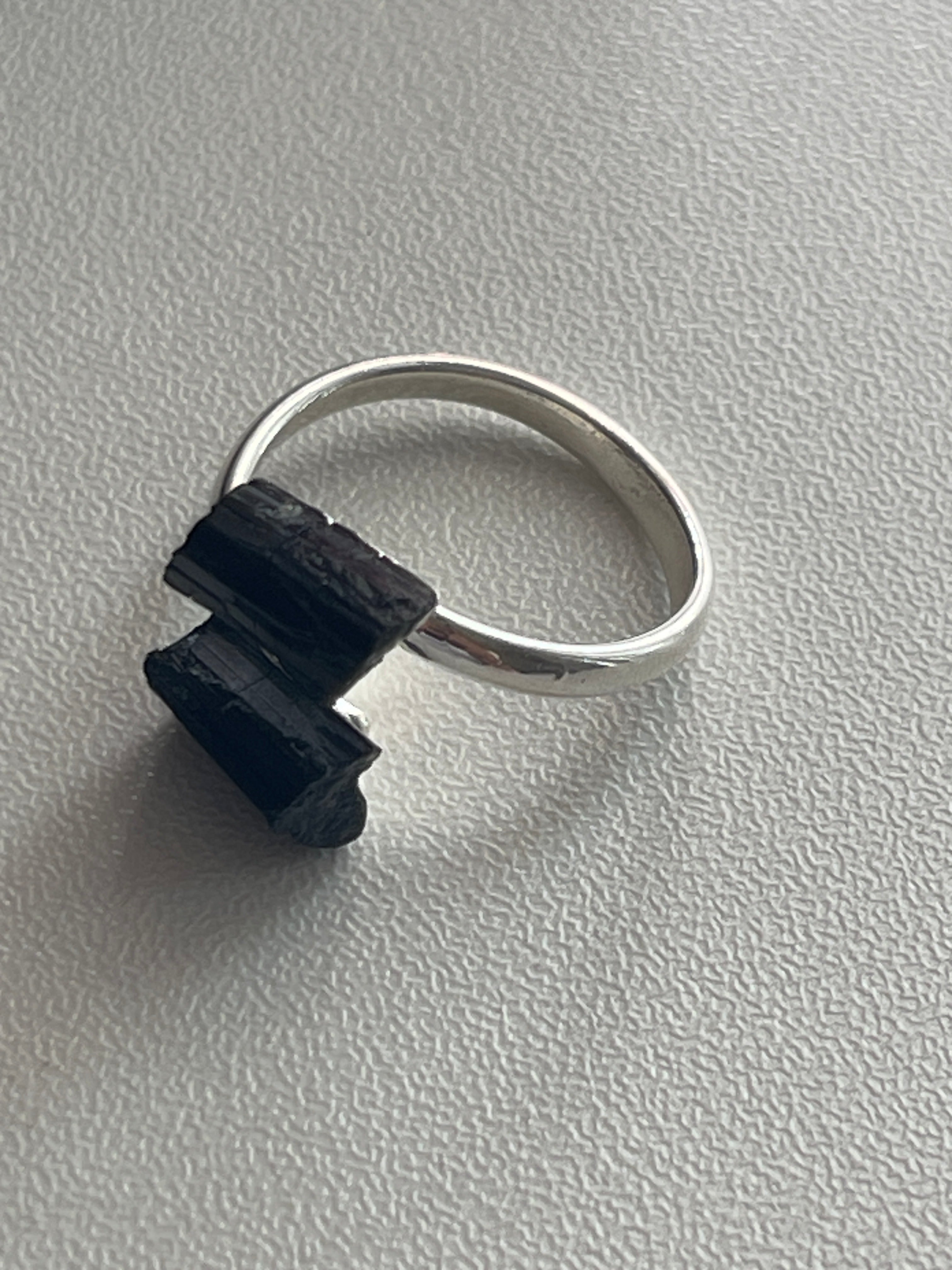 Black Adjustable Silver plated Tourmaline Ring at Pure Energy Crystals In Florida  Silver ring with a black stone on a gray background