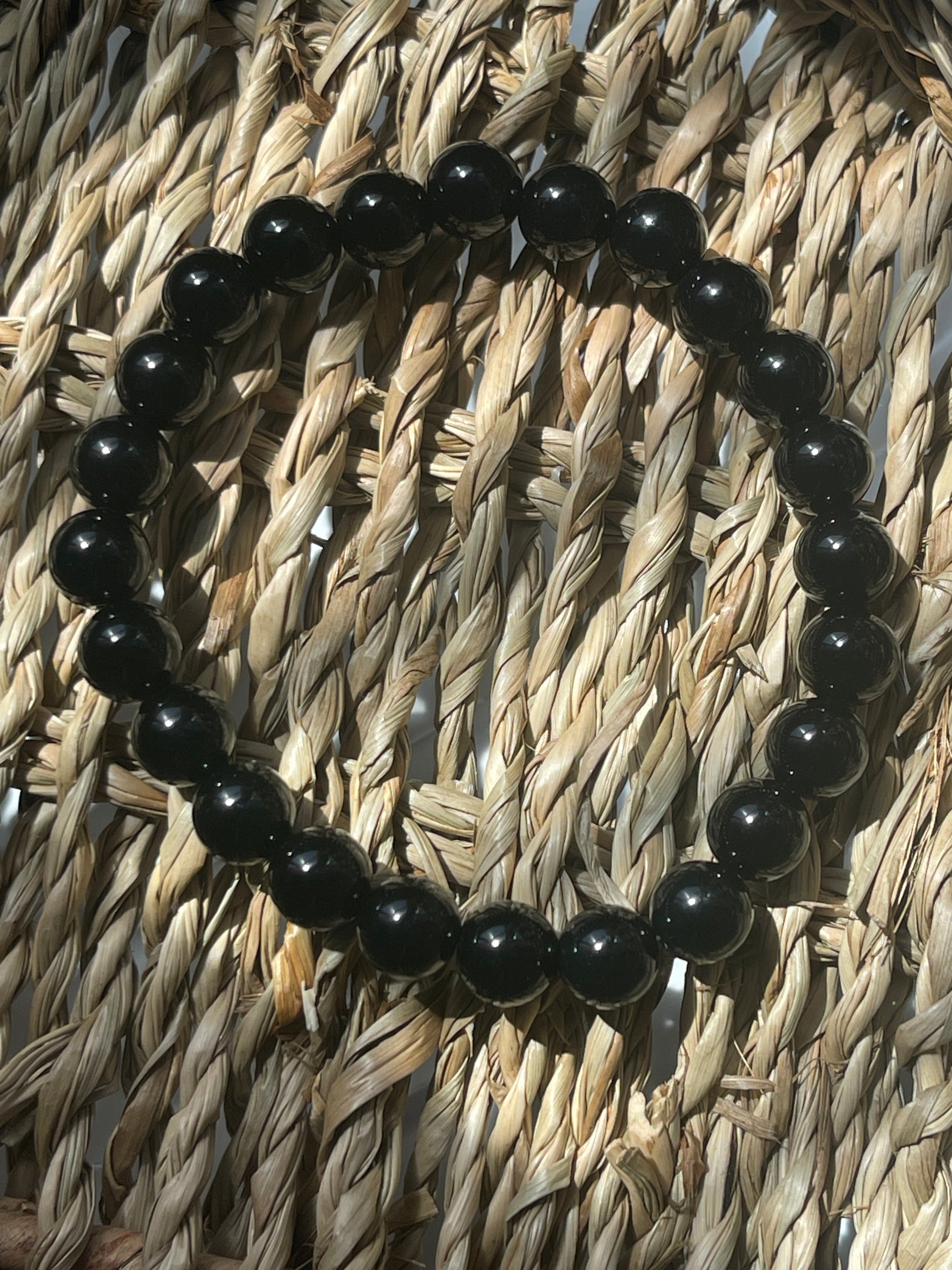 Black beaded bracelet on a woven surface Black Agate Bracelet