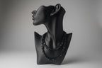 Black jewelry display with Black Obsidian Chip Necklace, blurred gray studio background