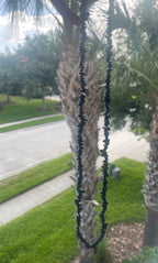 Black_Tourmaline_Chip_Necklace in front of a palm tree