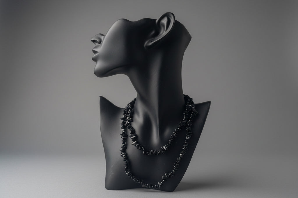 Black Tourmaline Chip Necklace in a studio with gray backdrop 
