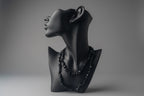 Black Tourmaline Chip Necklace in a studio with gray backdrop 