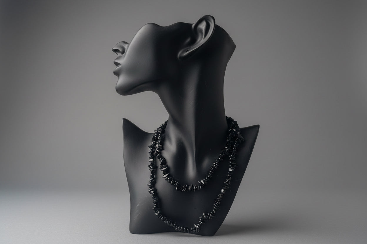 Black Tourmaline Chip Necklace in a studio with gray backdrop 