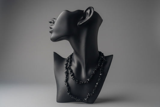 Black Tourmaline Chip Necklace in a studio with gray backdrop 