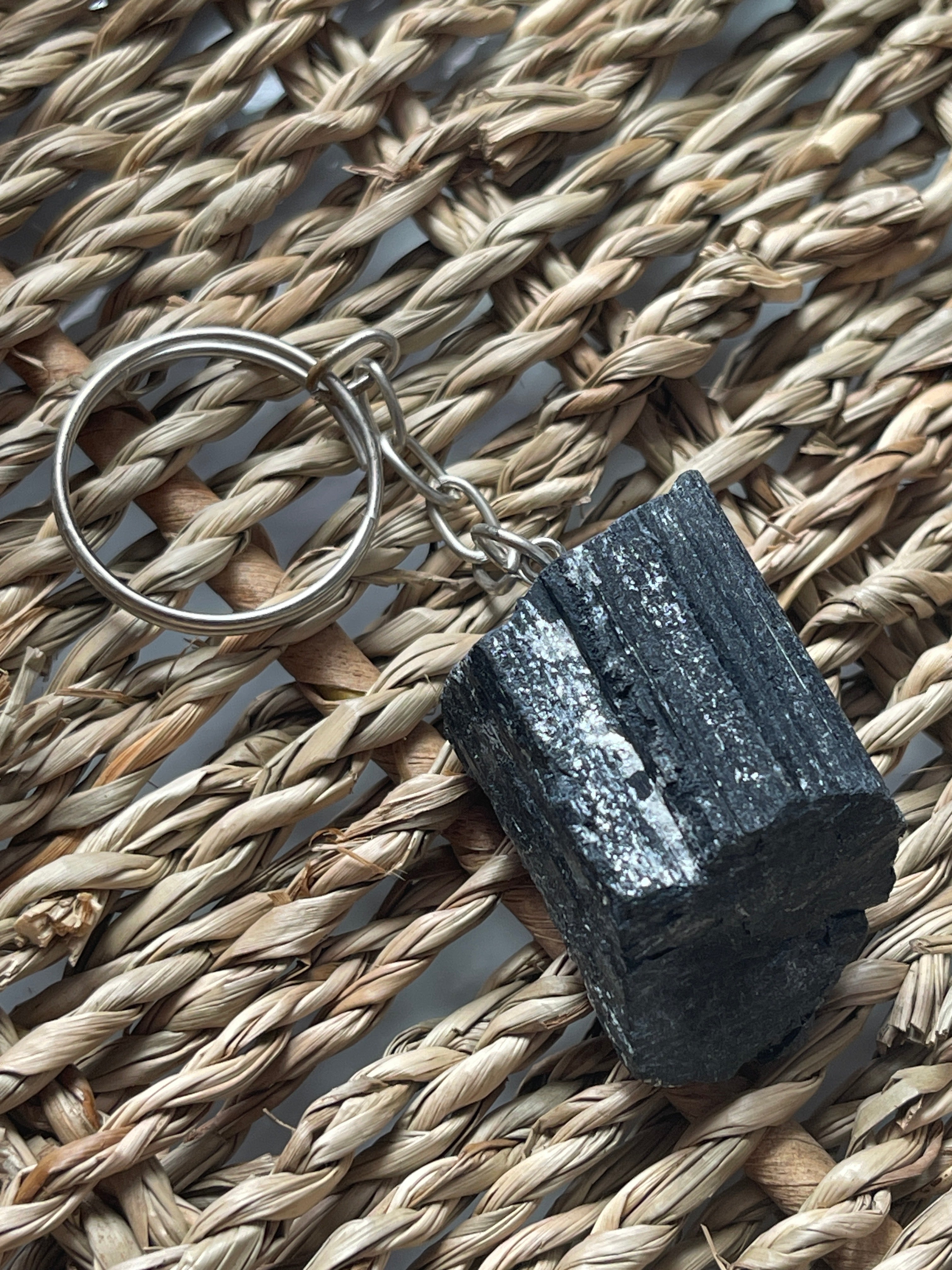Black_Tourmaline_Keychain_Black stone keychain on a woven mat