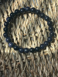 Blue beaded bracelet on a woven mat Blue Goldstone 8mm Bracelet at Pure Energy Crystals 
