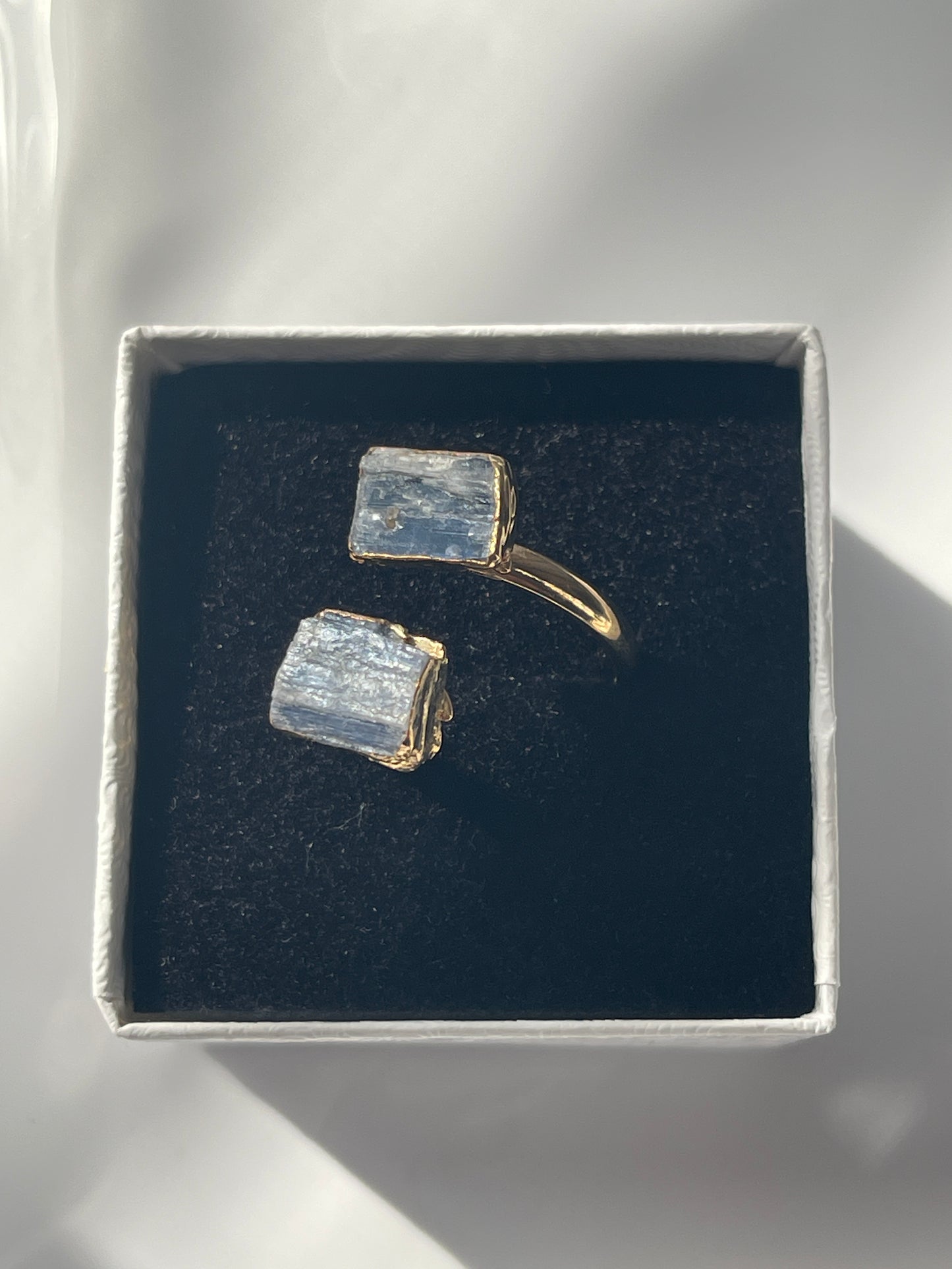 Blue Kyanite Adjustable Ring Gold Plated in a studio in Florida