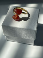 Carnelian Agate gold plated  ring with orange stones on a textured white jewelry box in Florida 