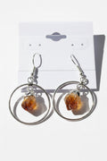 Citrine Point Circle Earrings, Silver hoop earrings with citrine stones on a textured surface