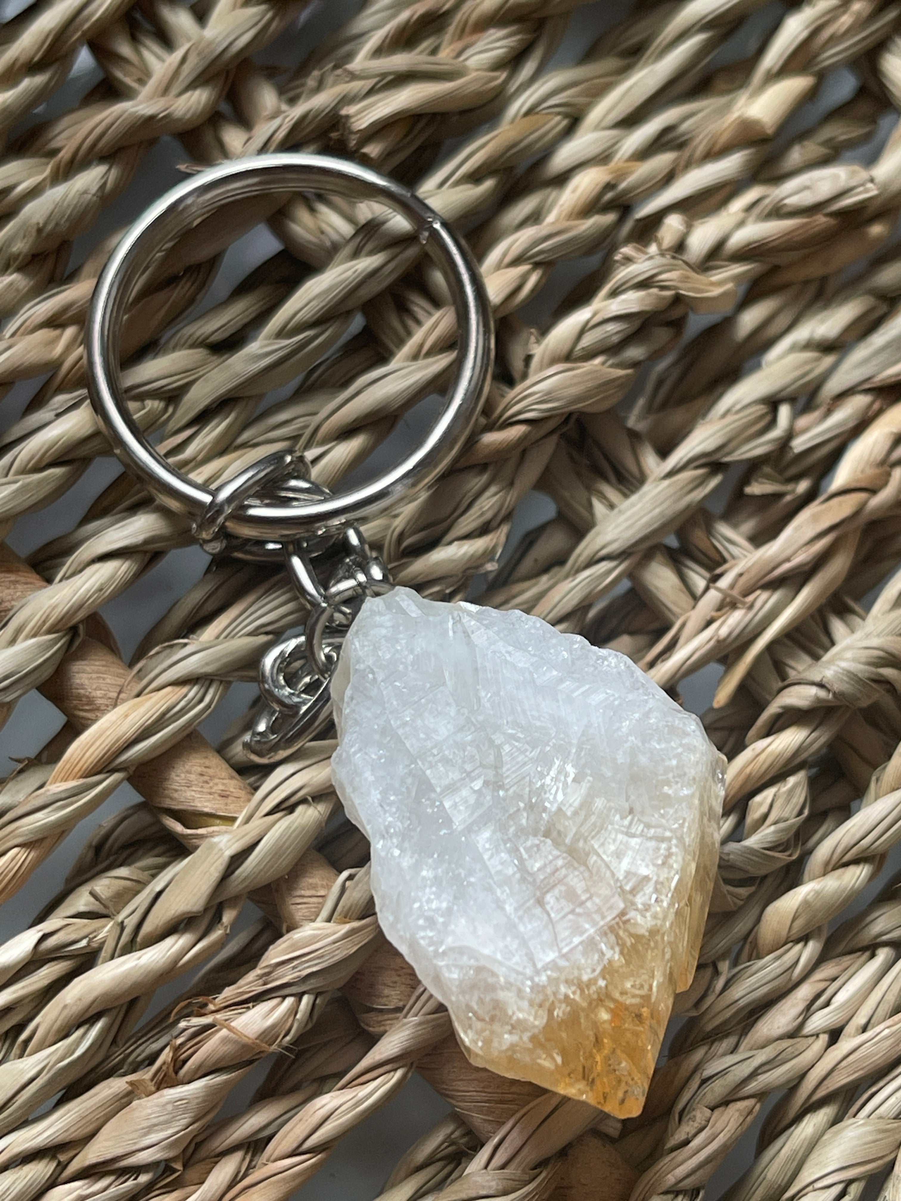 Citrine Keychain with a crystal on a woven surface