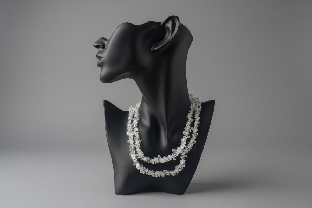 Clear_Quartz_Necklace_30-32_Inches on a black mannequin display with a blurred background
