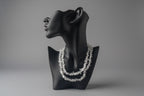 Clear_Quartz_Necklace_30-32_Inches on a black mannequin display with a blurred background