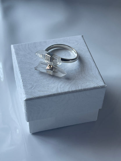 Silver Clear Quartz ring with a clear gemstone in a textured white jewelry box on a matching white background