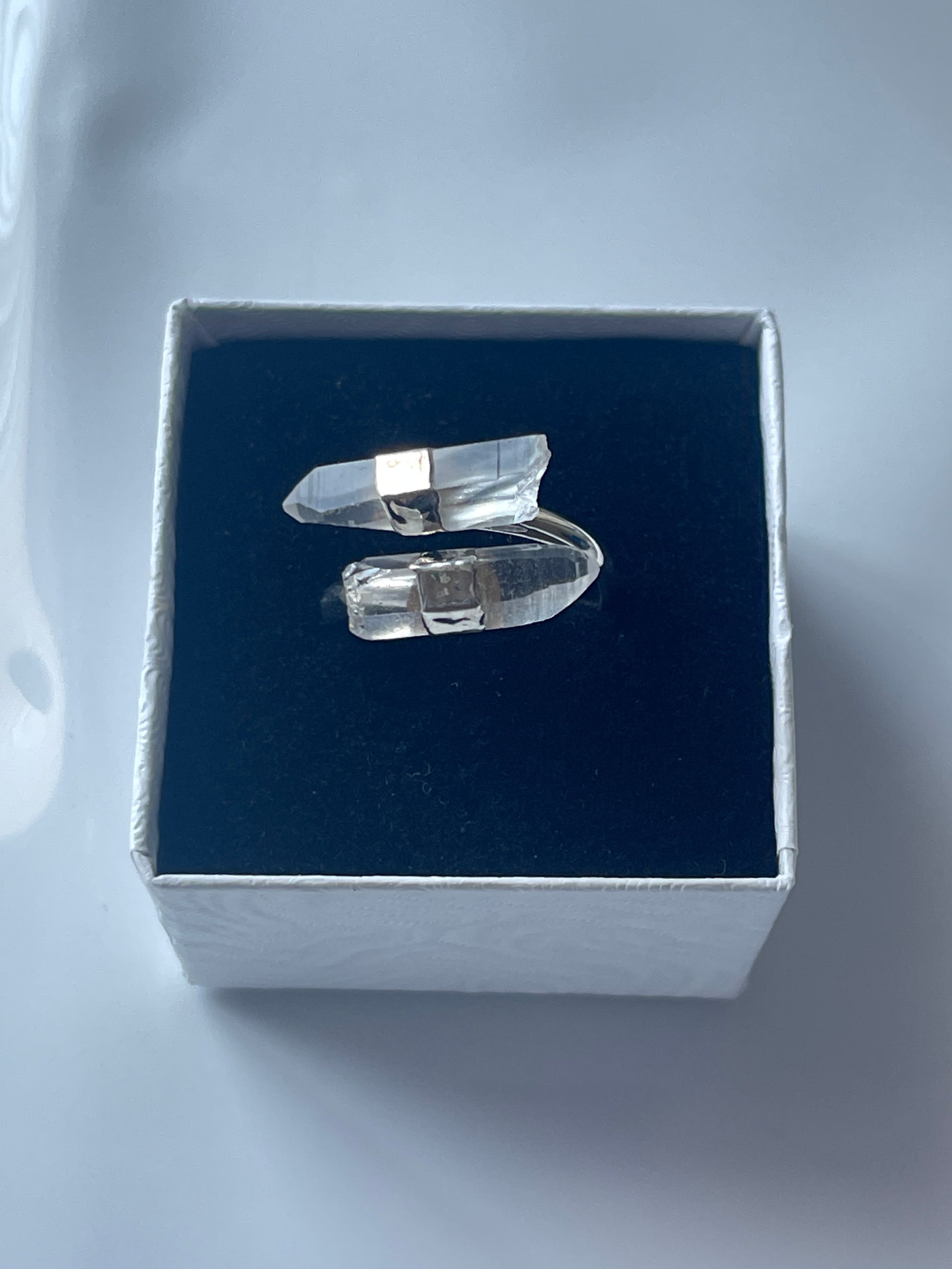 Clear quartz silver plated ring in a jewelry box on a white background 