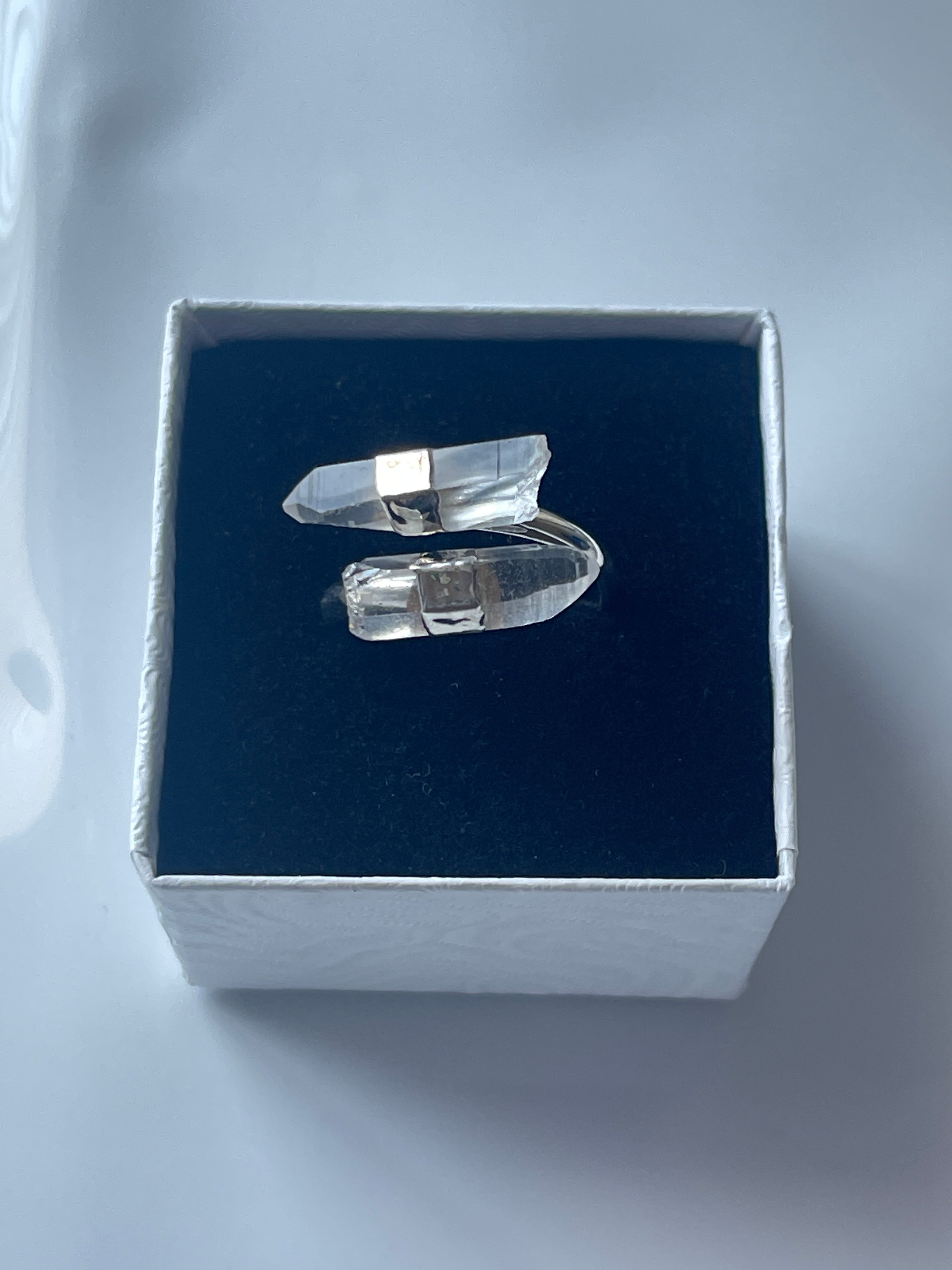 Clear quartz silver plated ring in a jewelry box on a white background 