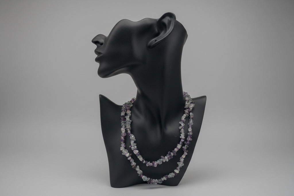 Black mannequin head with Fluorite_Necklace_30-32_Inches in a gray studio 