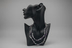 Black mannequin head with Fluorite_Necklace_30-32_Inches in a gray studio 