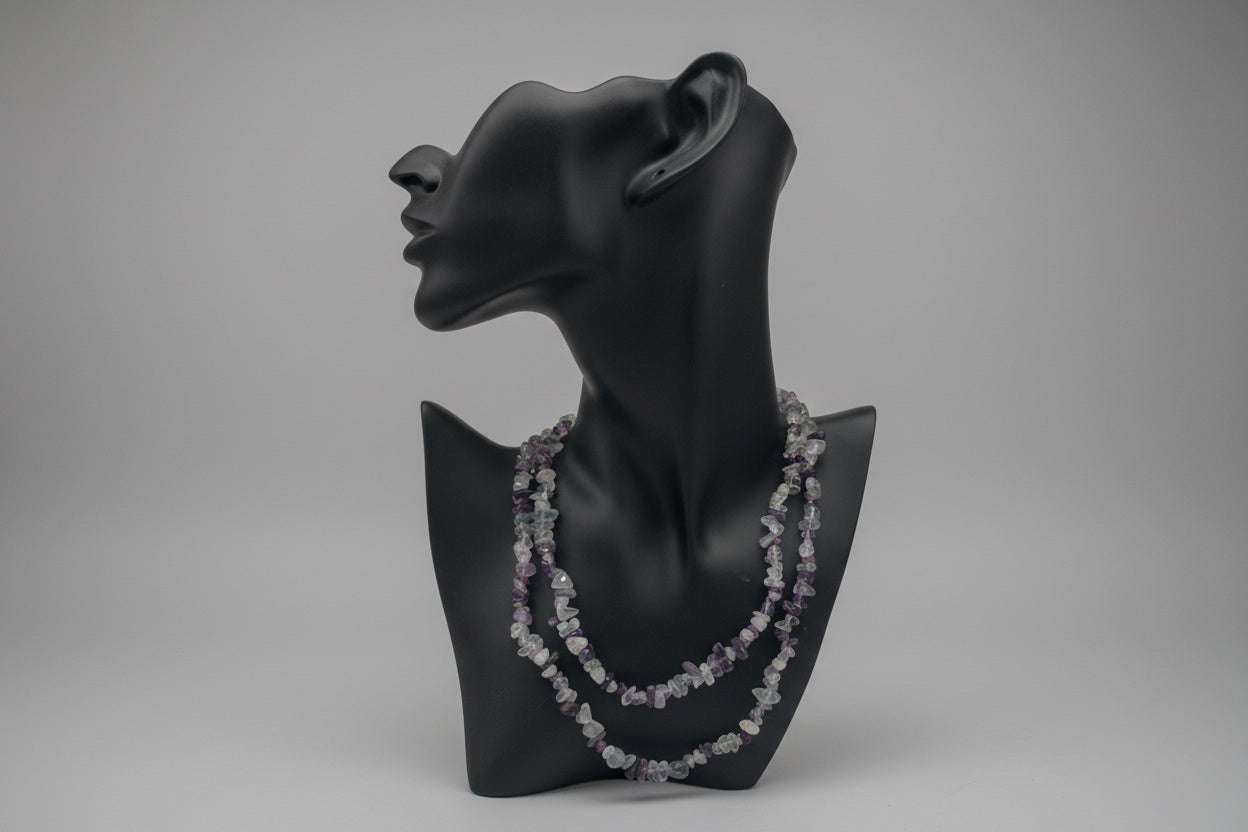 Black mannequin head with Fluorite_Necklace_30-32_Inches in a gray studio 