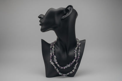 Black mannequin head with Fluorite_Necklace_30-32_Inches in a gray studio 