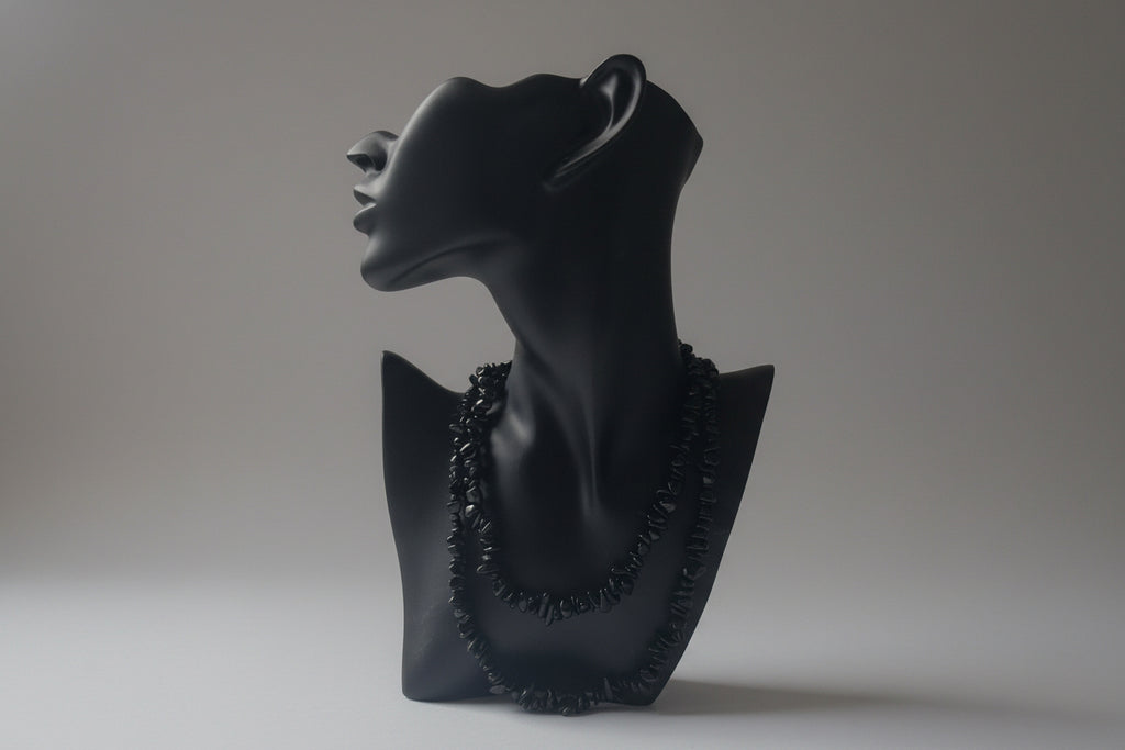 Black jewelry display showcasing a Green_Goldstone_Necklace_30-32_Inches