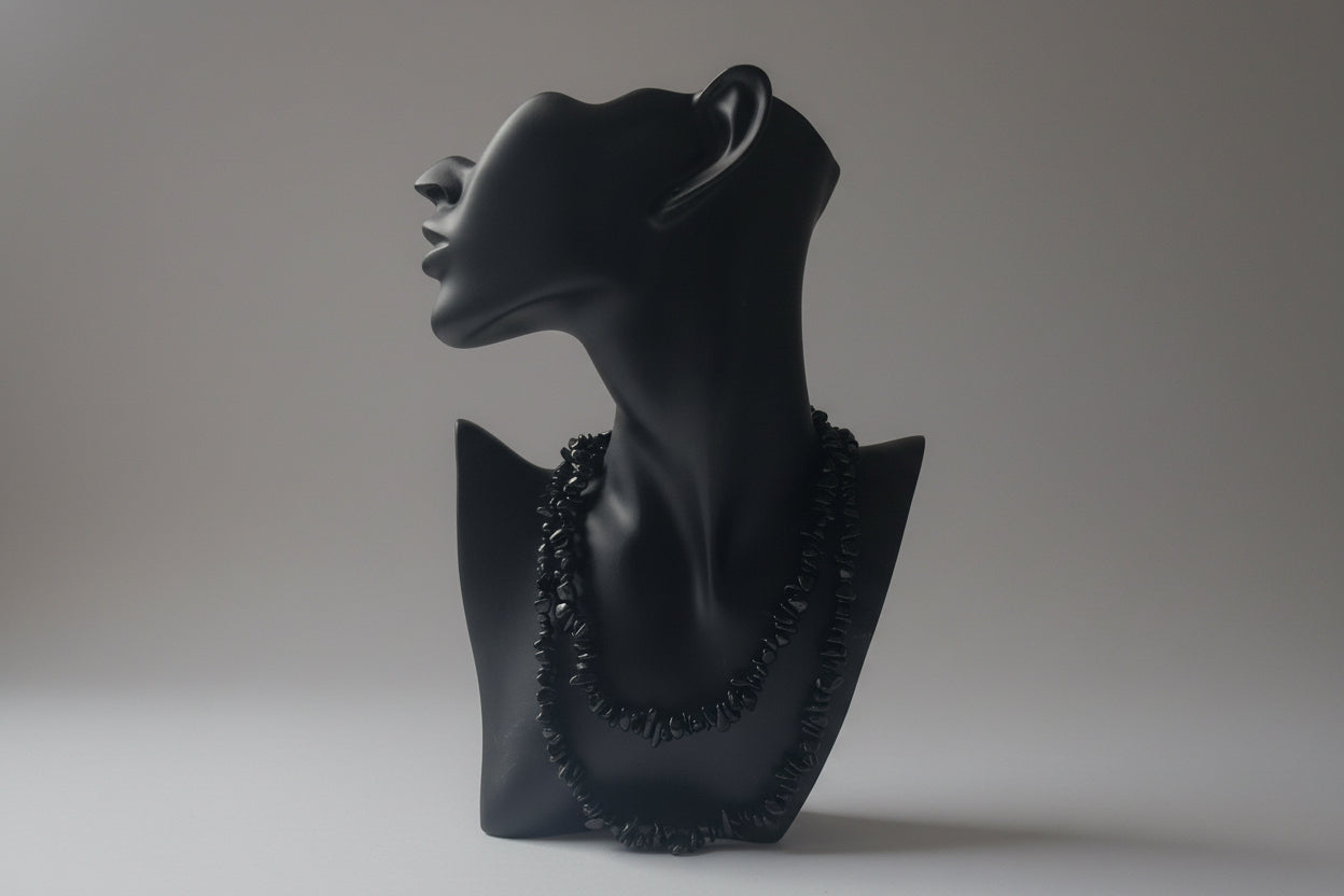 Black jewelry display showcasing a Green_Goldstone_Necklace_30-32_Inches