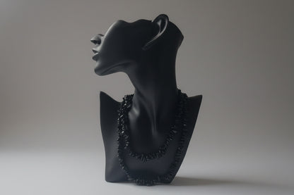 Black jewelry display showcasing a Green_Goldstone_Necklace_30-32_Inches