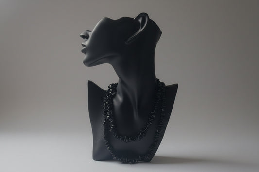 Black jewelry display showcasing a Green_Goldstone_Necklace_30-32_Inches