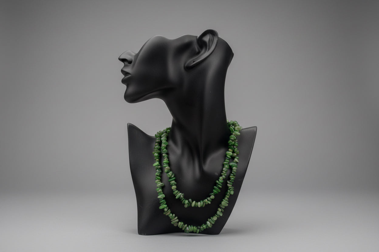 Green_Jade_Necklace_30-32_Inches green beads on a black mannequin head against a blurred outdoor background