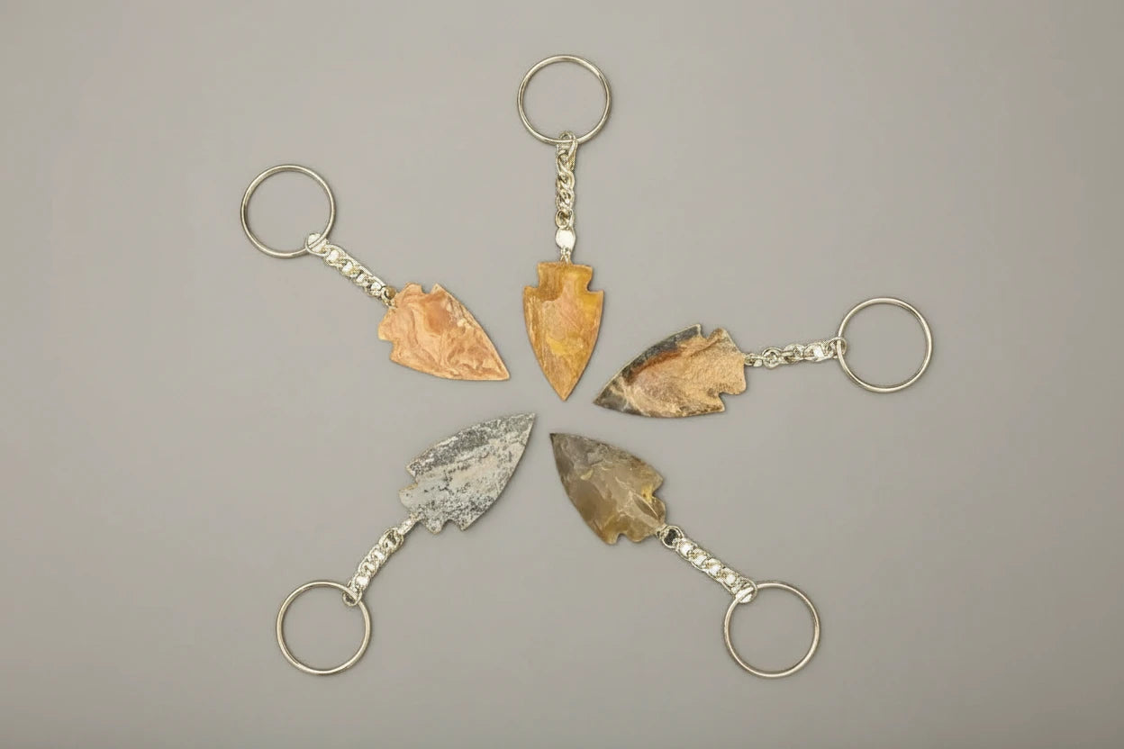 Handcrafted Arrowhead Keychain on a gray studio backdrop.