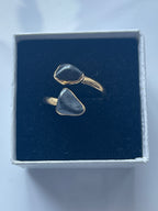 Hematite Adjustable Ring Gold Plated inside a black and white jewelry box