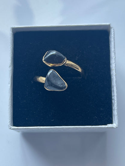 Hematite Adjustable Ring Gold Plated inside a black and white jewelry box