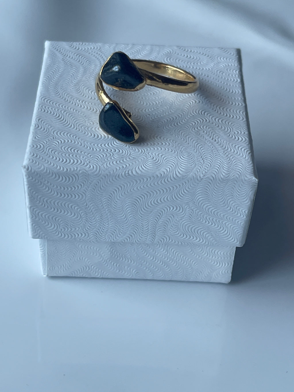 Hematite Adjustable Ring Gold Plated on top of a jewelry box in Florida 