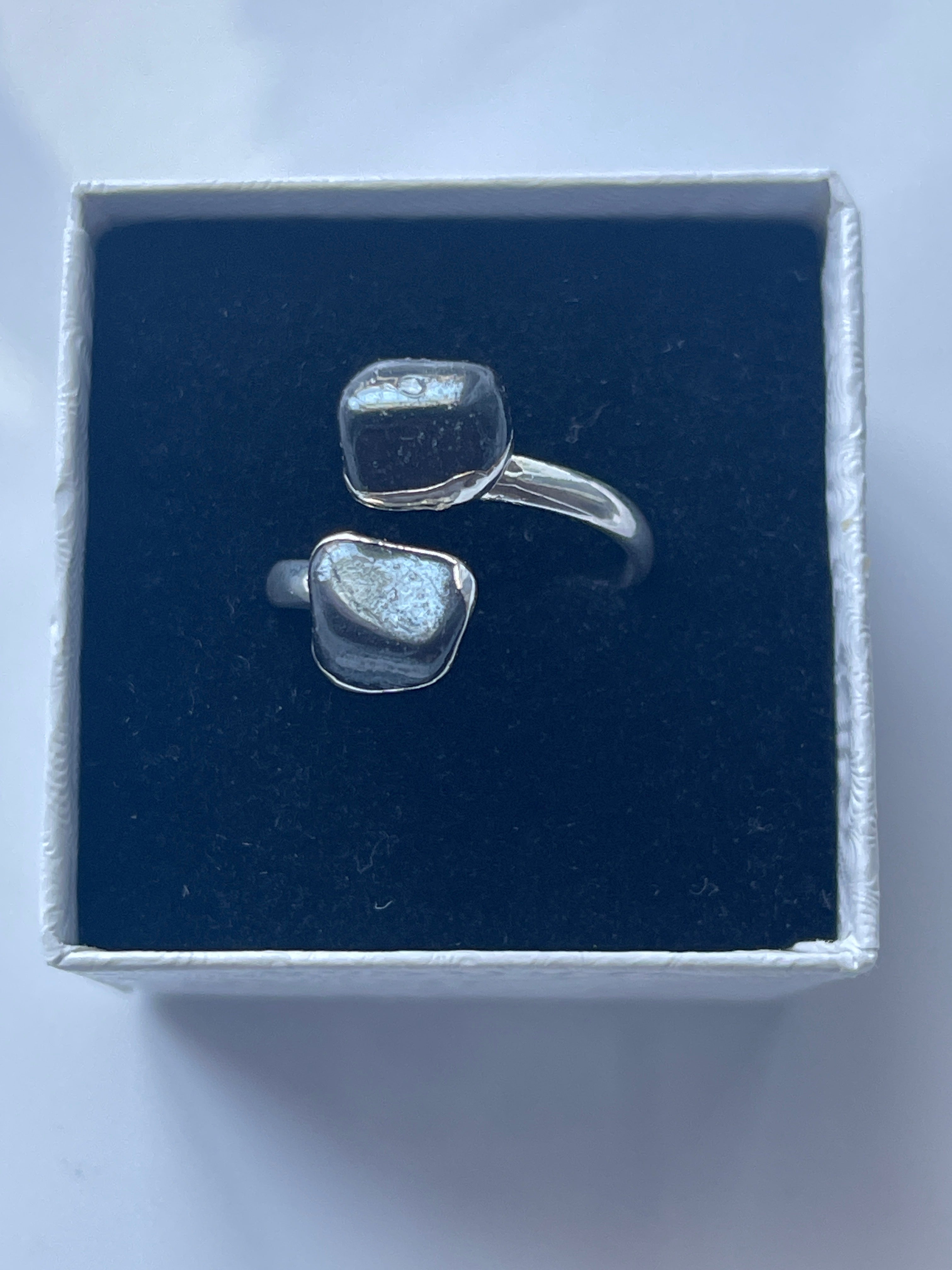 Hematite Adjustable Ring Silver Plated inside a jewelry white and black box
