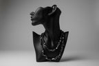 Black jewelry display with Hematite necklace and a gray backdrop 