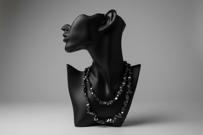 Black jewelry display with Hematite necklace and a gray backdrop 