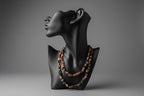 Black mannequin head with colorful Mixed_Color_Tourmaline_Necklace_30-32_Inches beads on a stand in gray studio.