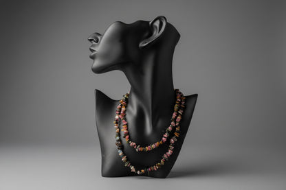 Black mannequin head with colorful Mixed_Color_Tourmaline_Necklace_30-32_Inches beads on a stand in gray studio.